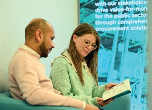 Two business professionals reading a book 