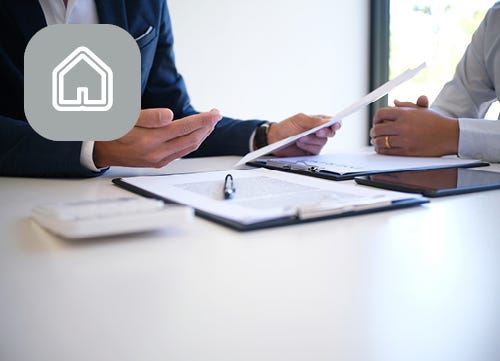 Business professionals talking over a document