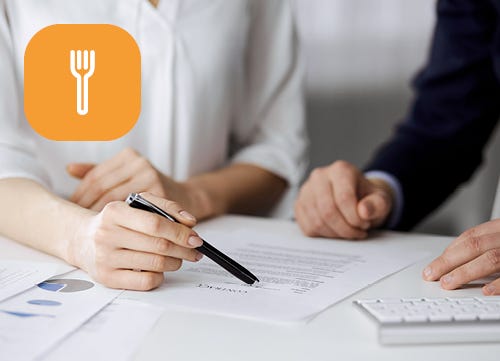 Business professionals signing a document