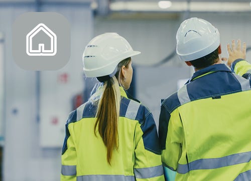 Two business professionals in Hi Vis and Hard Hats