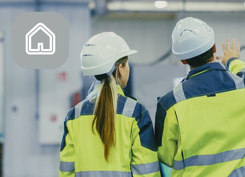 Business professional in Hi Vis and hard hats