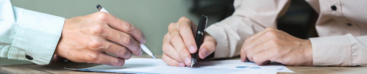 business professionals writing on a piece of paper